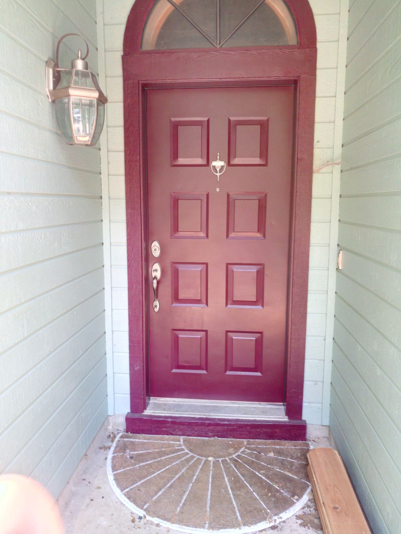 New exterior entry door with painted trim and hardware