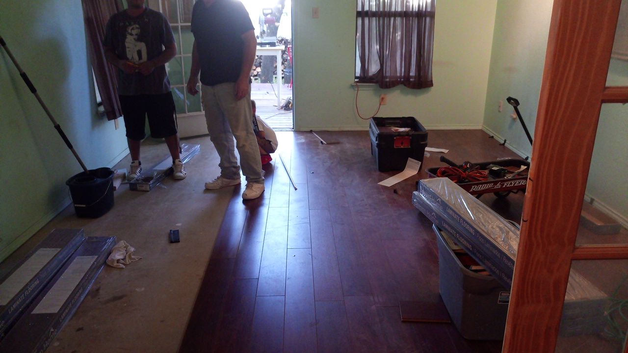 Laminate wood flooring installation in progress